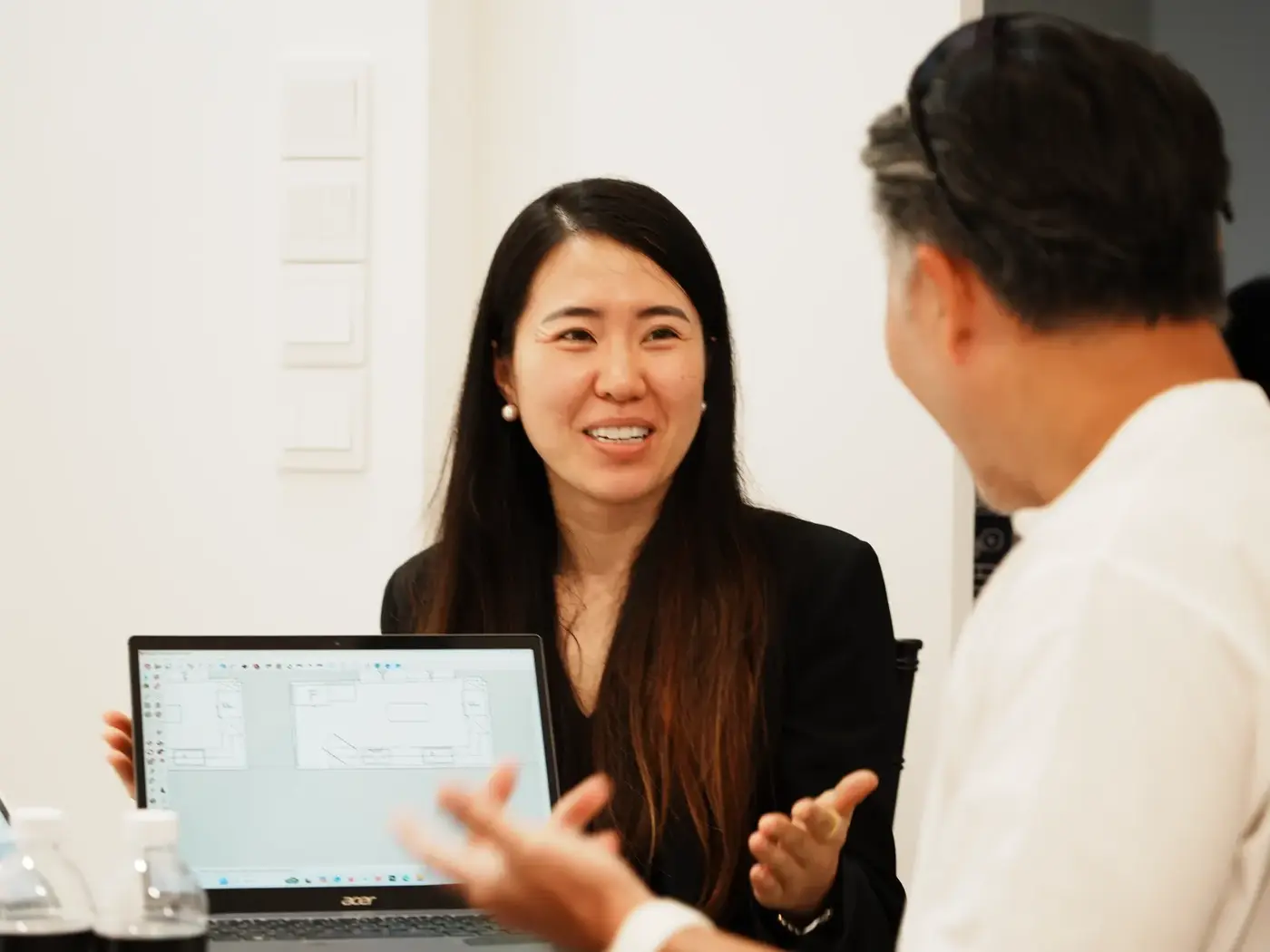 Designer walking a homeowner through plans on a laptop